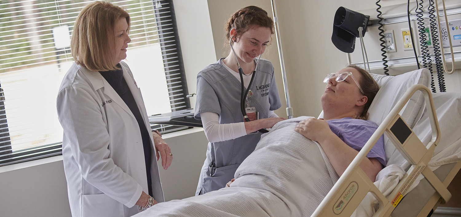 A nursing student and their professor examine a patient